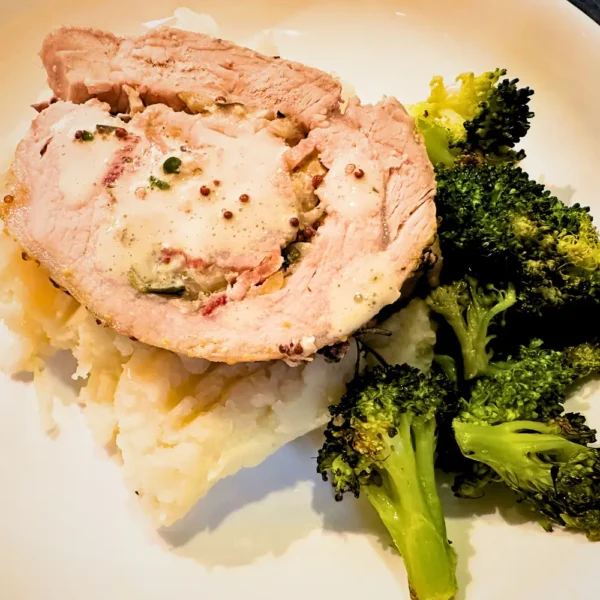 German Herb-Stuffed Pork Loin with Mustard Pan Sauce, Sauerkraut-Potato Mash, Roasted Broccoli, and Applesauce