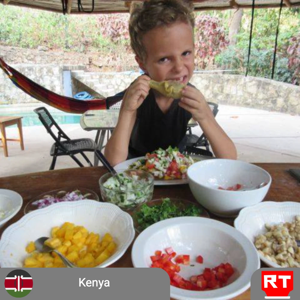 East African Chicken Curry with colorful condiments and steamed rice (includes complimentary surprise dessert)